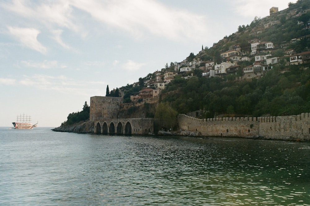 a boat is in the water near a hill