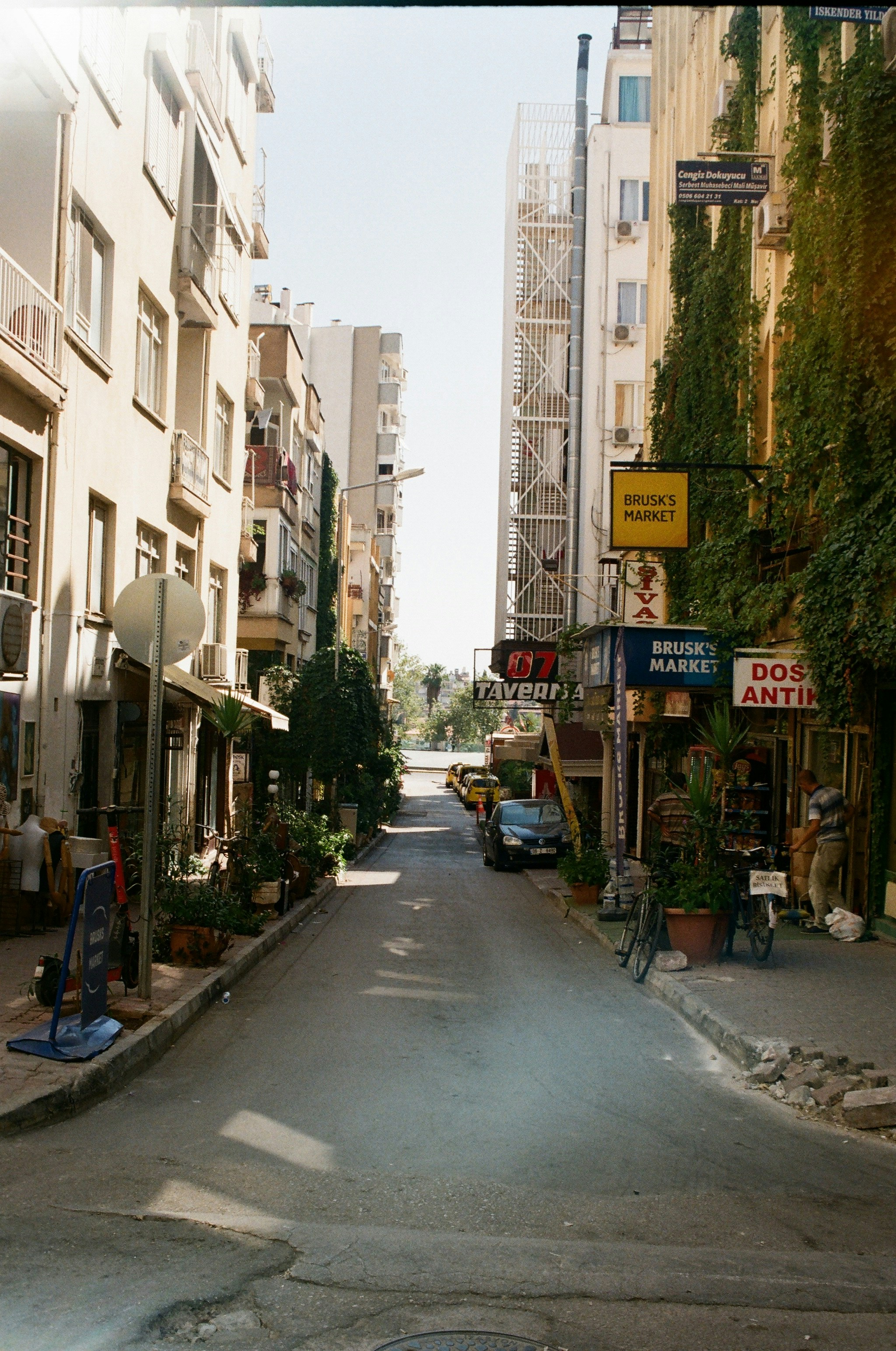 an empty street with cars parked on the side of it