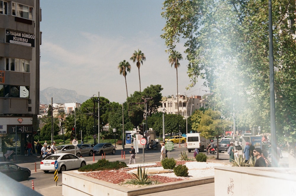 a city street filled with lots of traffic next to tall buildings