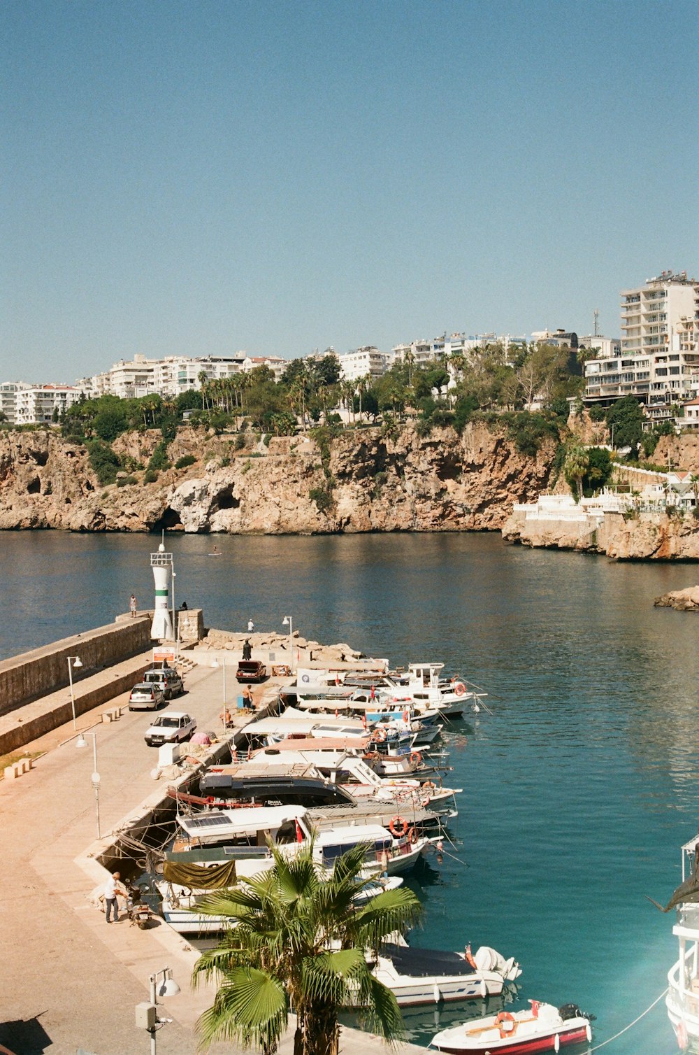 a harbor filled with lots of boats next to a city