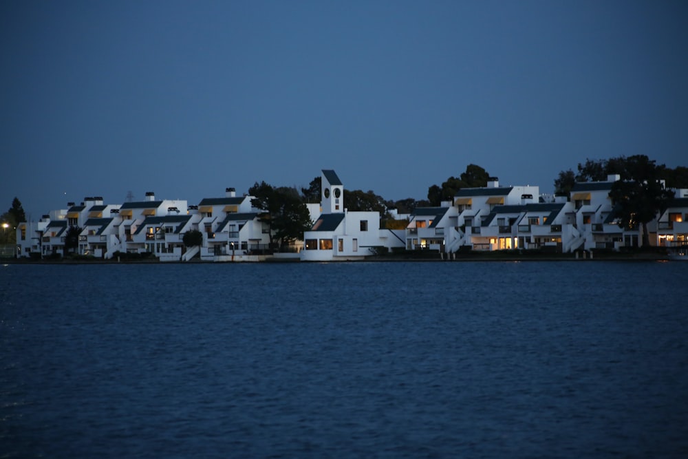 a row of houses sitting on top of a lake