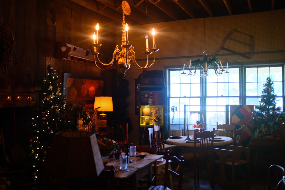 a living room with a christmas tree and a chandelier