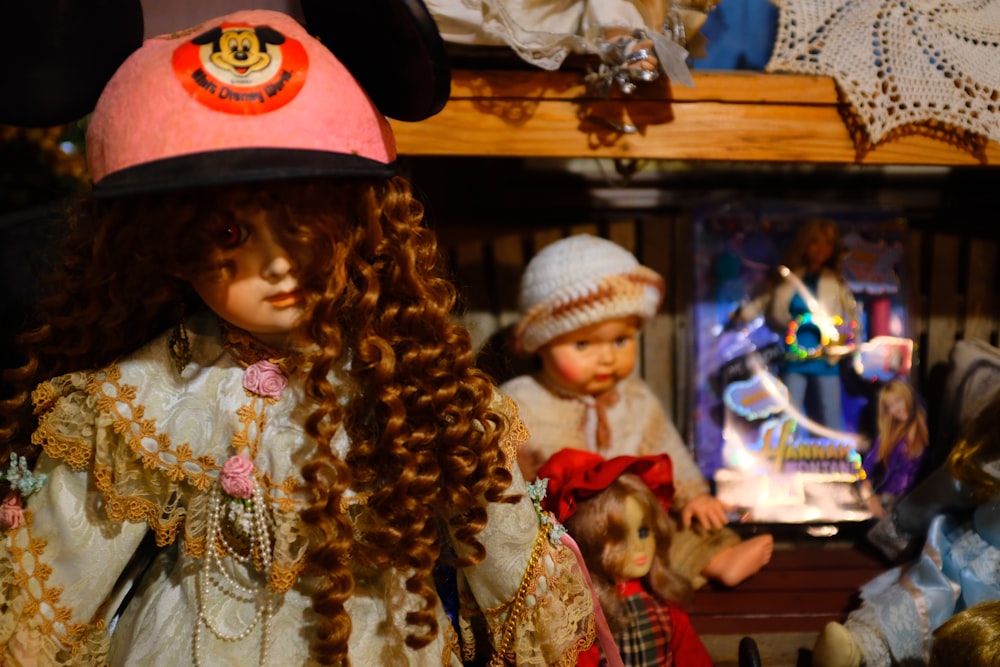 a group of dolls that are sitting on a shelf