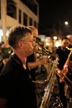 a man playing a trumpet on a city street