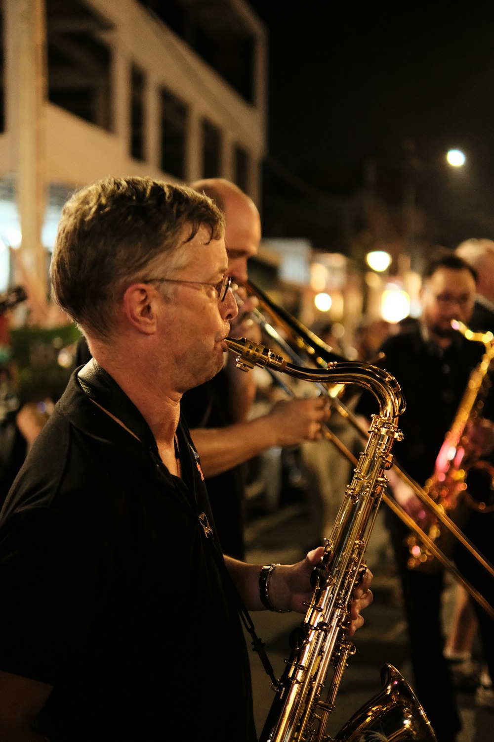 a man playing a trumpet on a city street