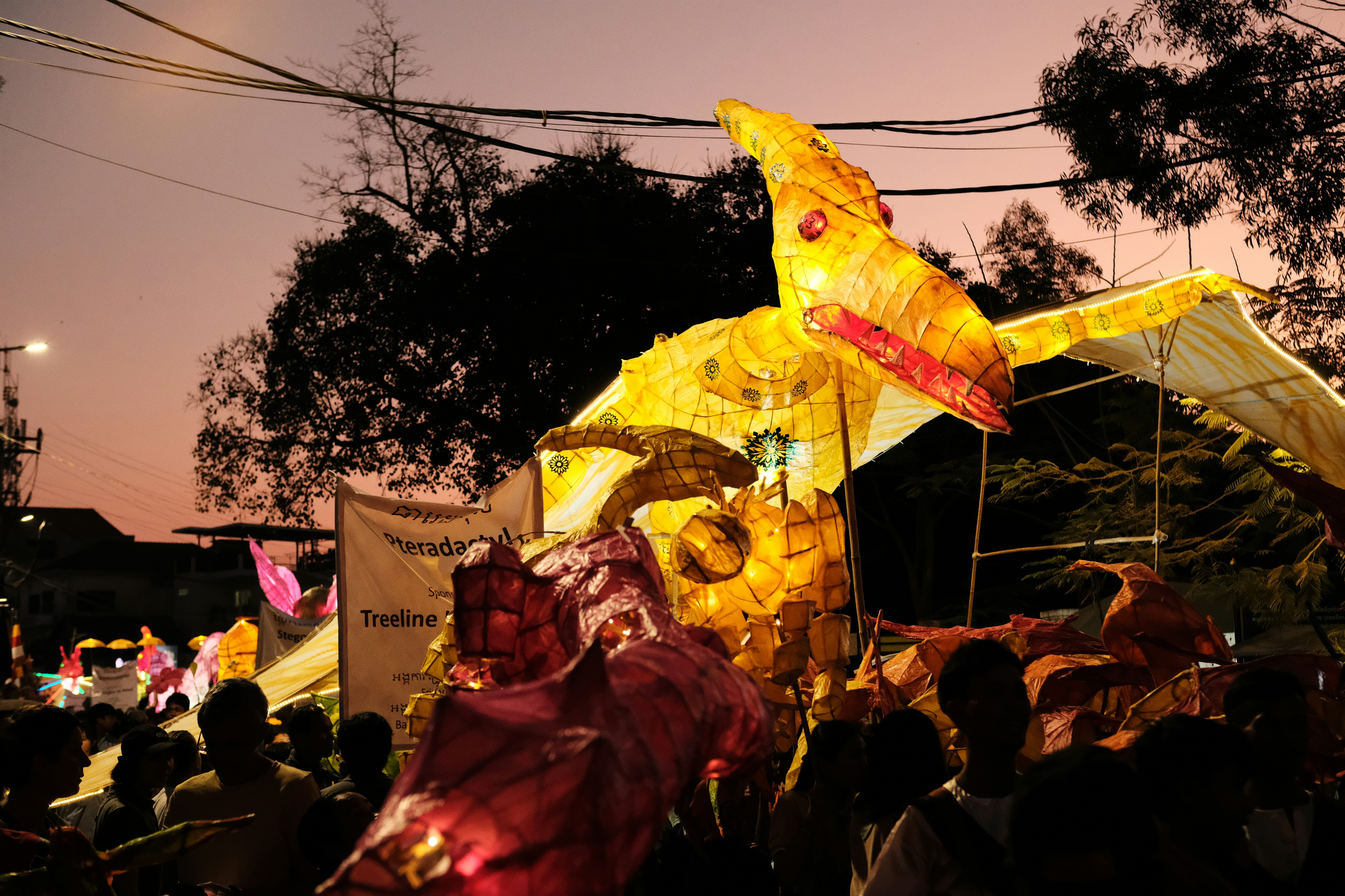 a large group of people standing around a float, 