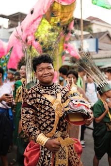 a man in a costume is holding a mask