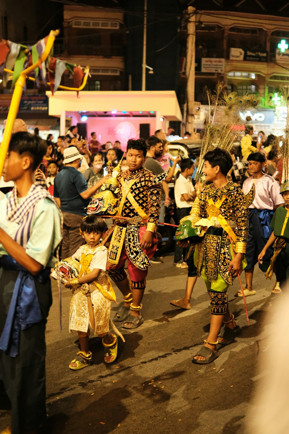 a group of people walking down a street at night