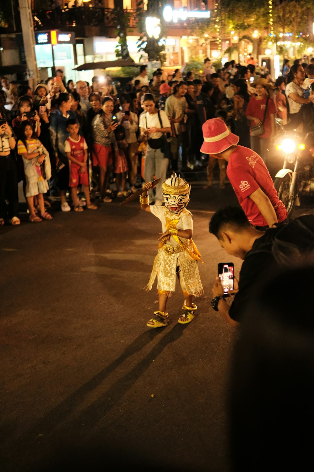 a man taking a picture of a boy in costume