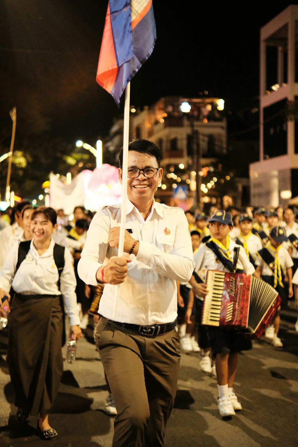 a man holding a flag and an accordion