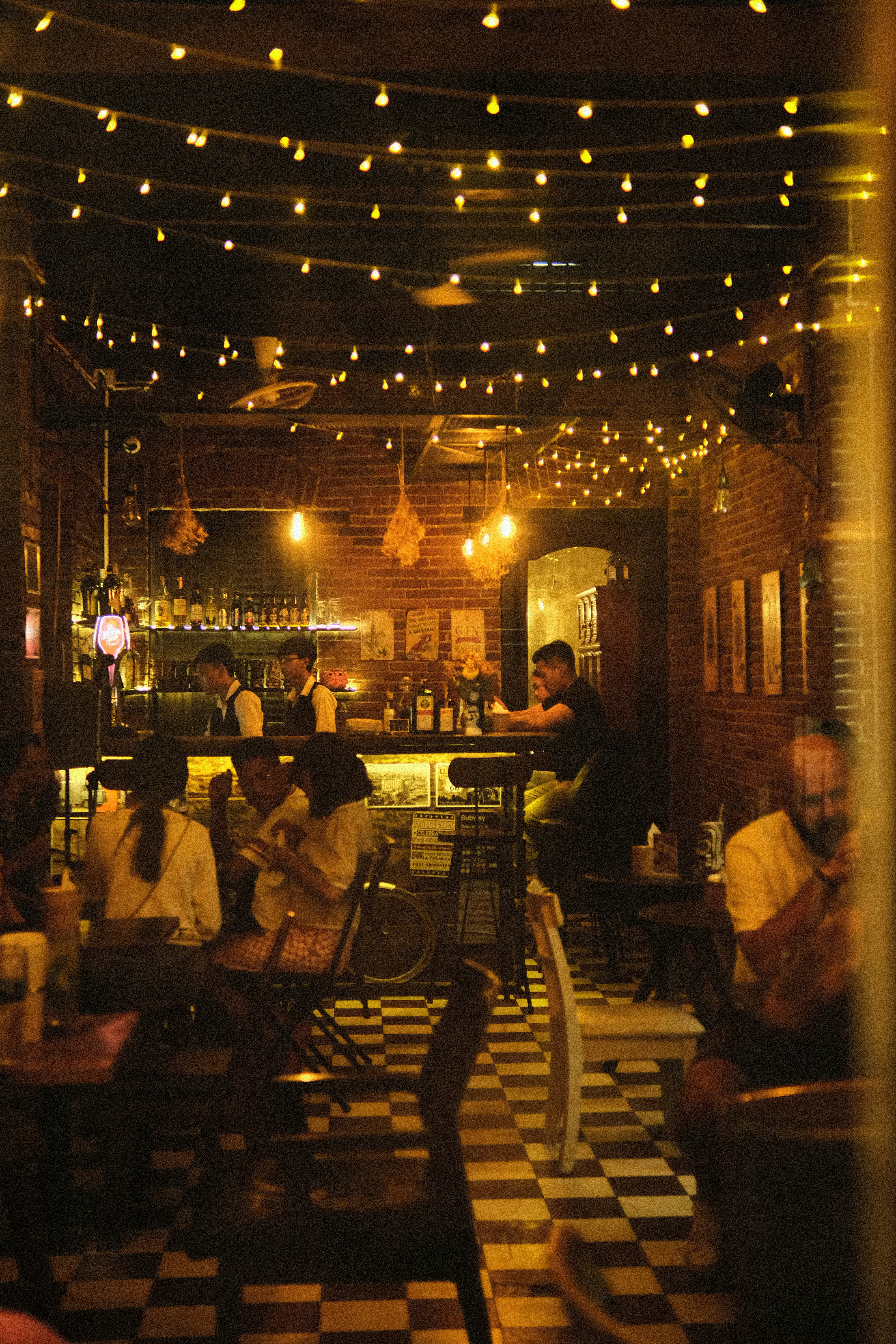 a group of people sitting at tables in a restaurant