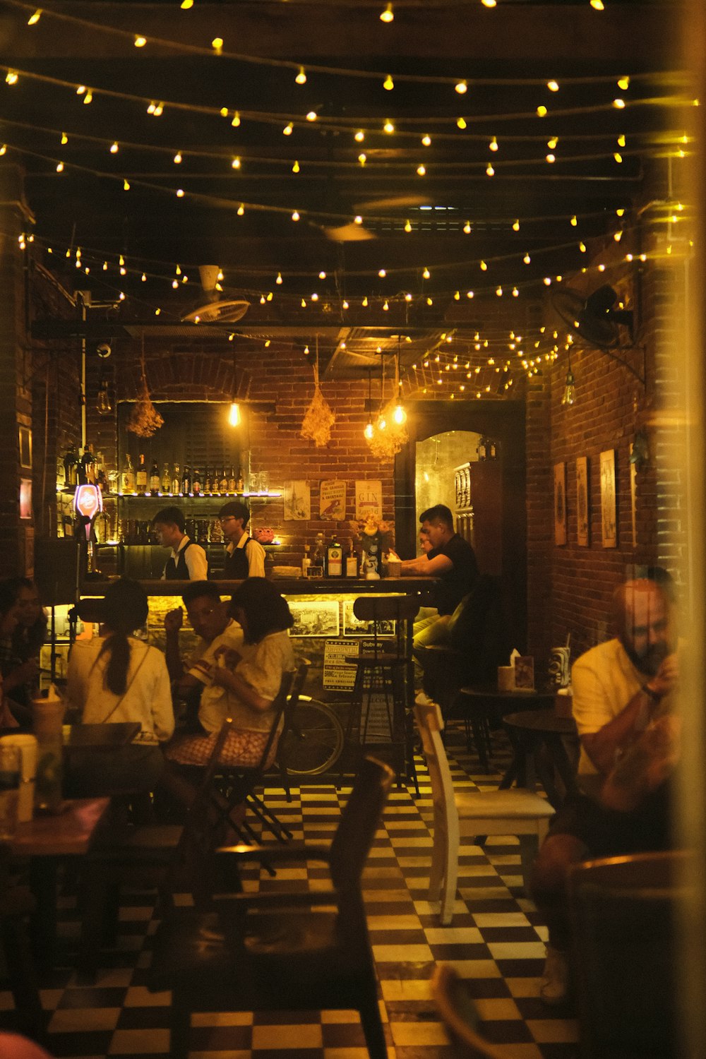 a group of people sitting at tables in a restaurant