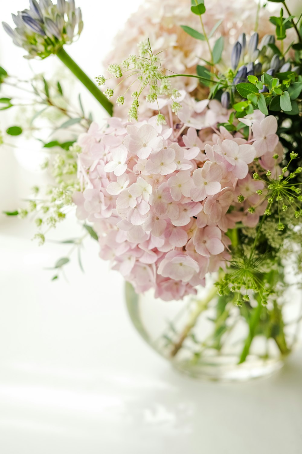 a vase filled with lots of pink and white flowers