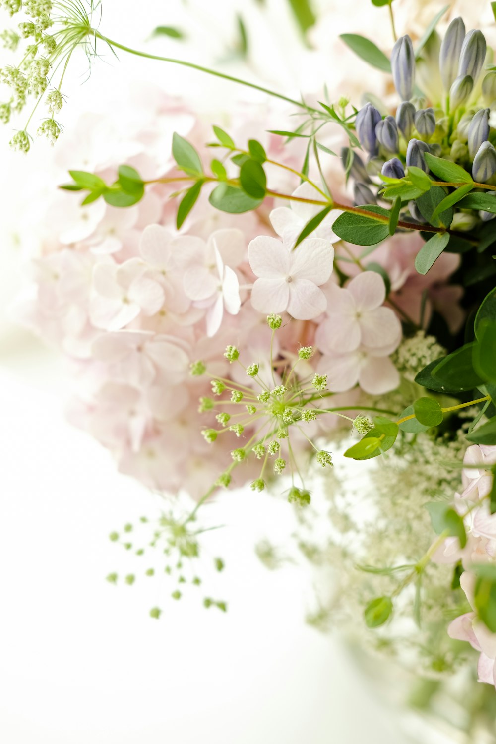 a vase filled with lots of pink and white flowers