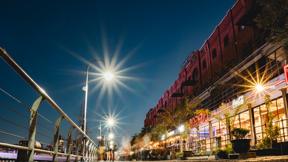 a city street at night with street lights and buildings