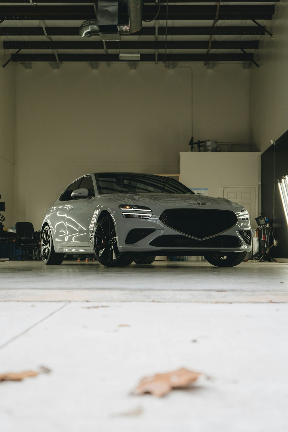 a car parked in a garage next to another car