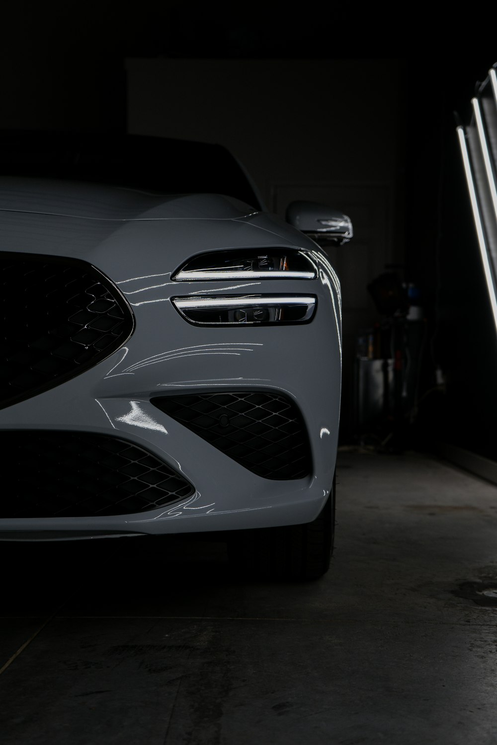 a close up of the front of a car in a garage