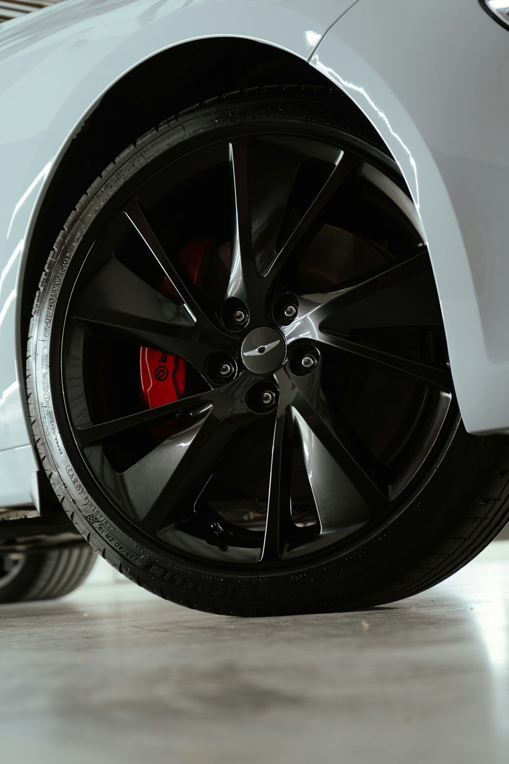 a close up of a car tire on a white car