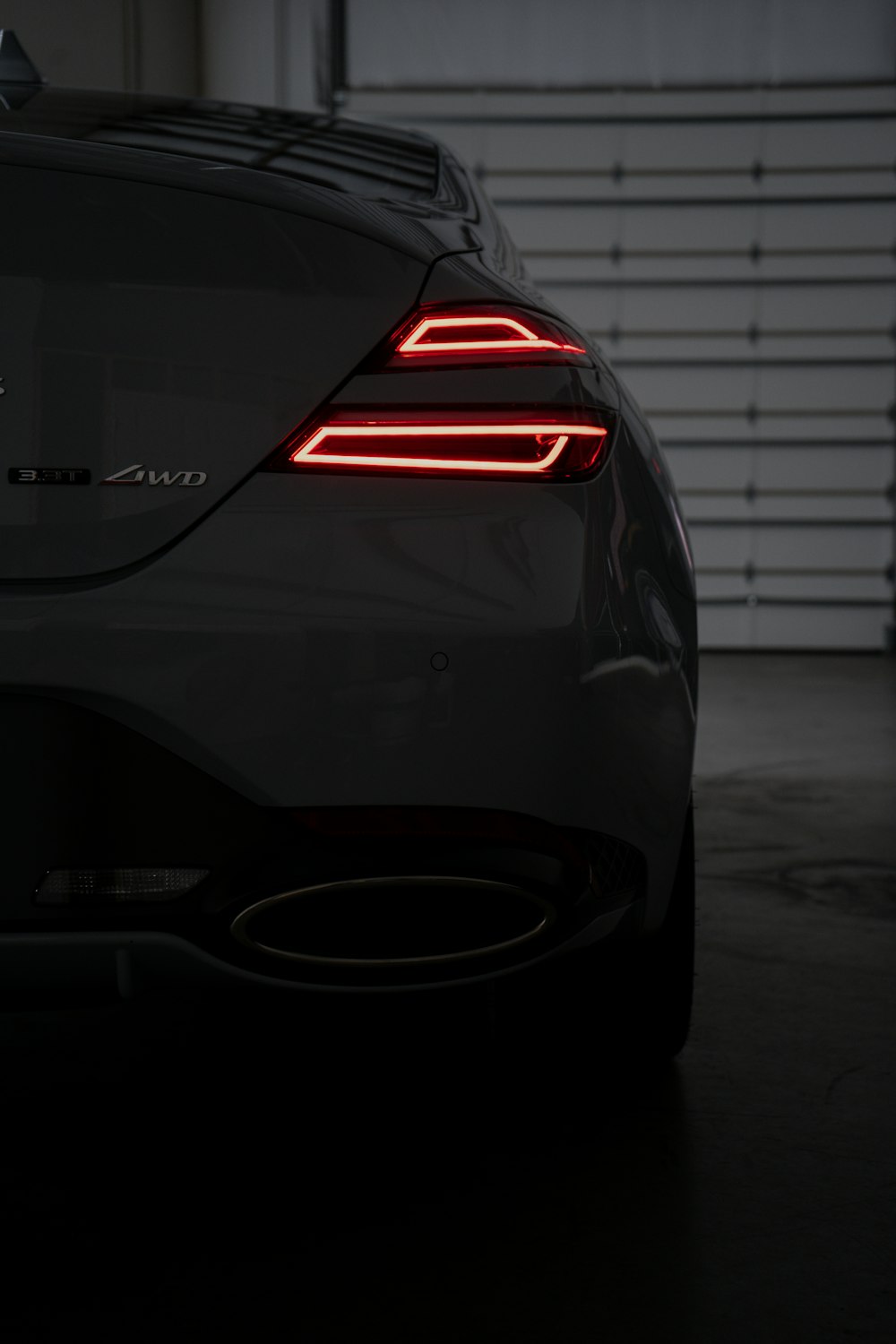 the tail lights of a car in a garage