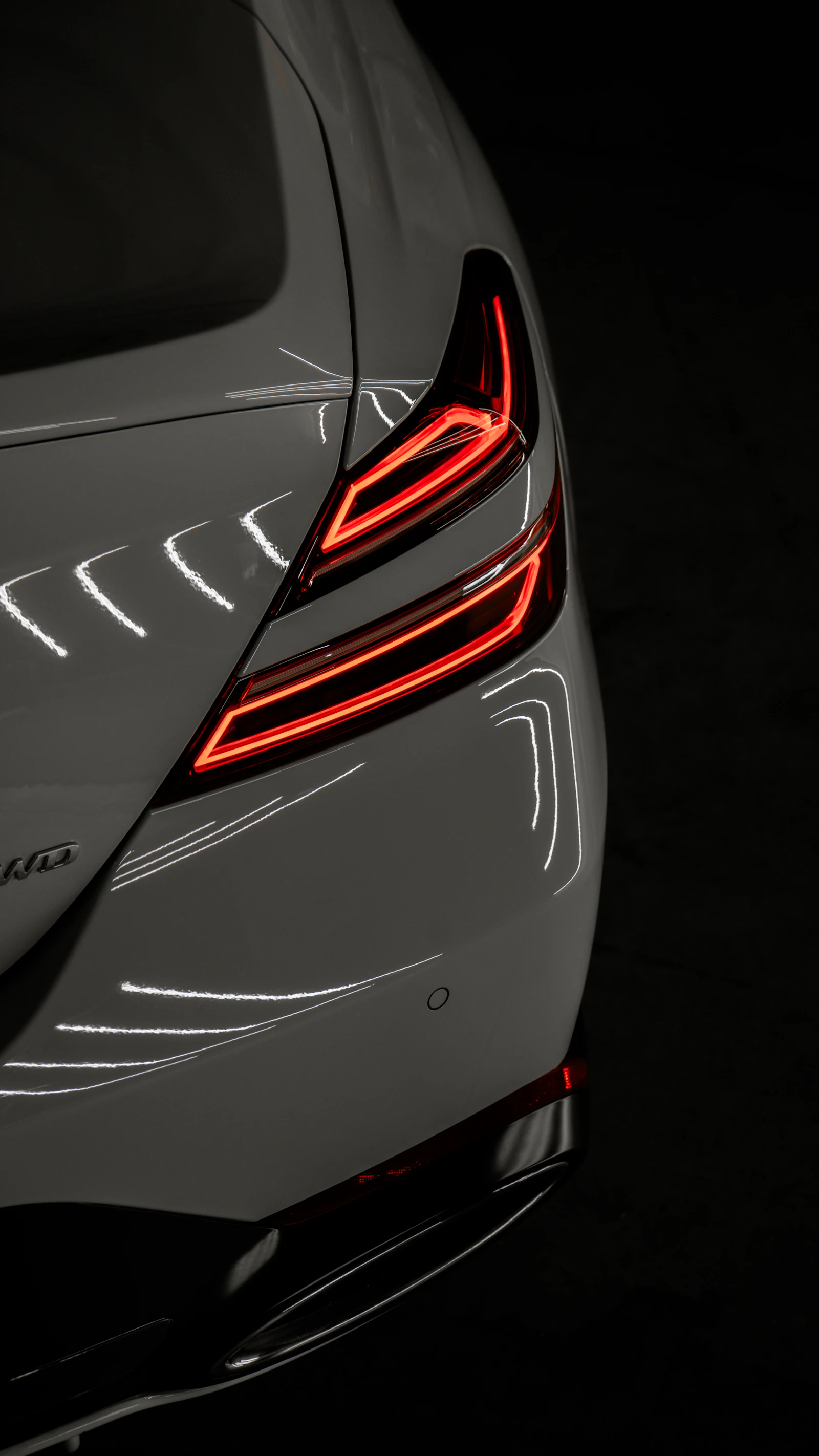 Glossy tail lights of a coated car