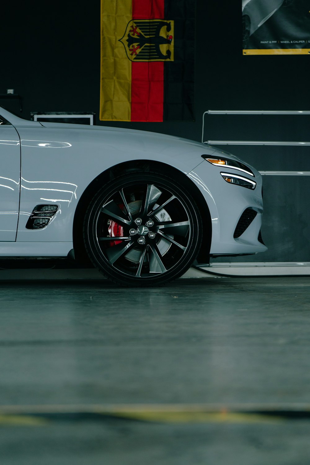 a white sports car parked in a garage