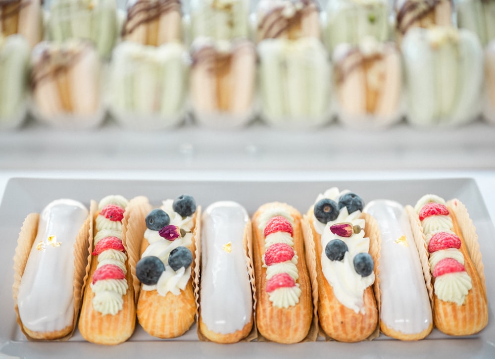 a row of pastries sitting on top of a white plate