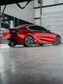a red sports car parked in a garage