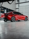 a red sports car parked in a garage