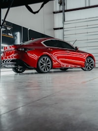 a red sports car parked in a garage