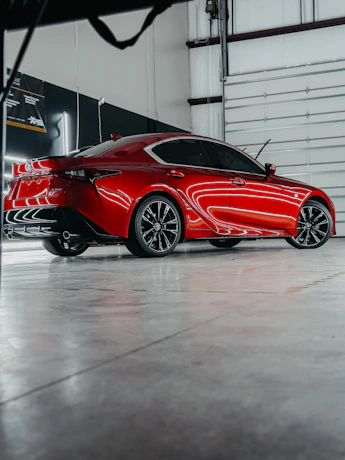 a red sports car parked in a garage
