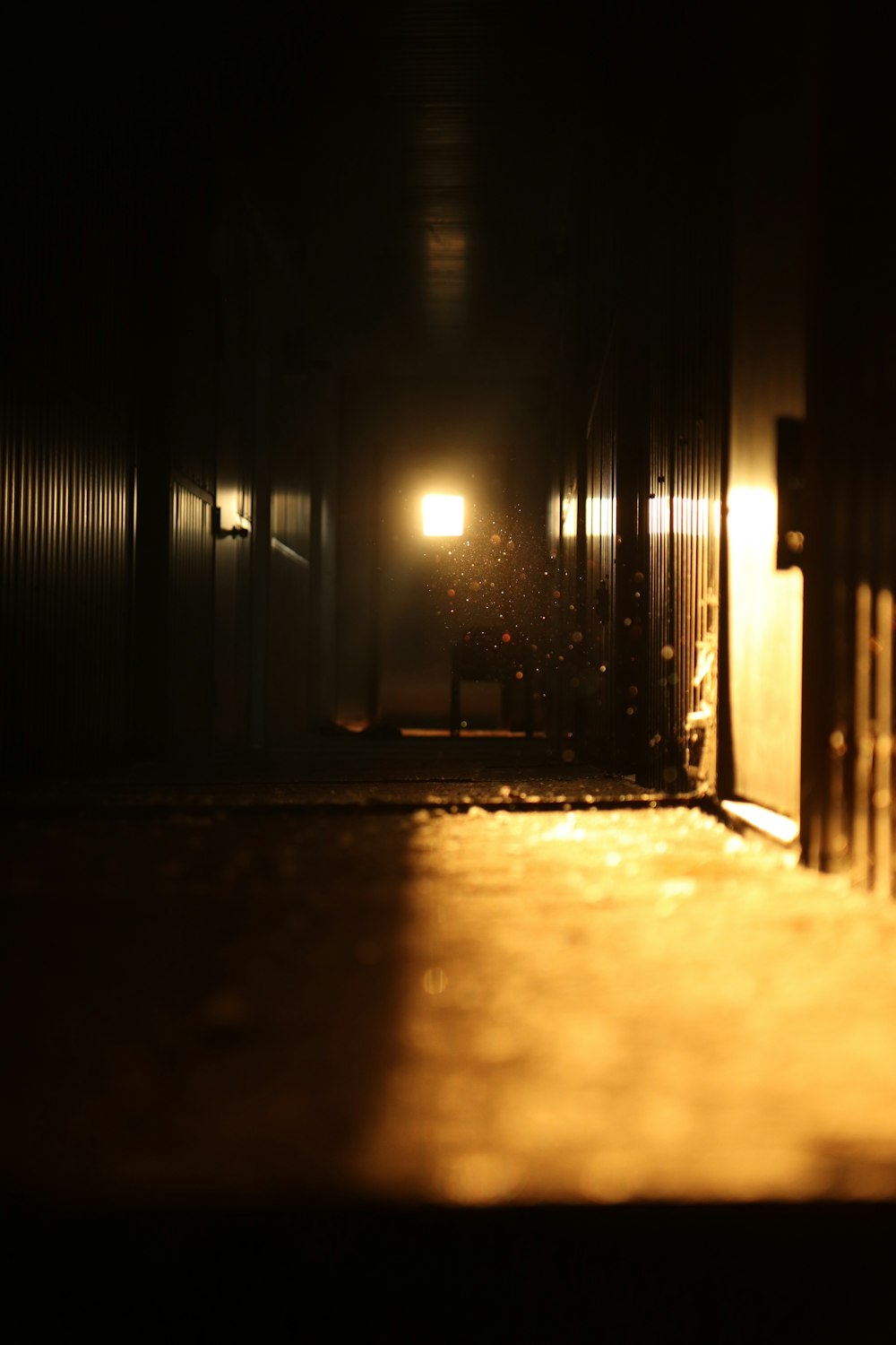 a dark hallway with a light at the end of it