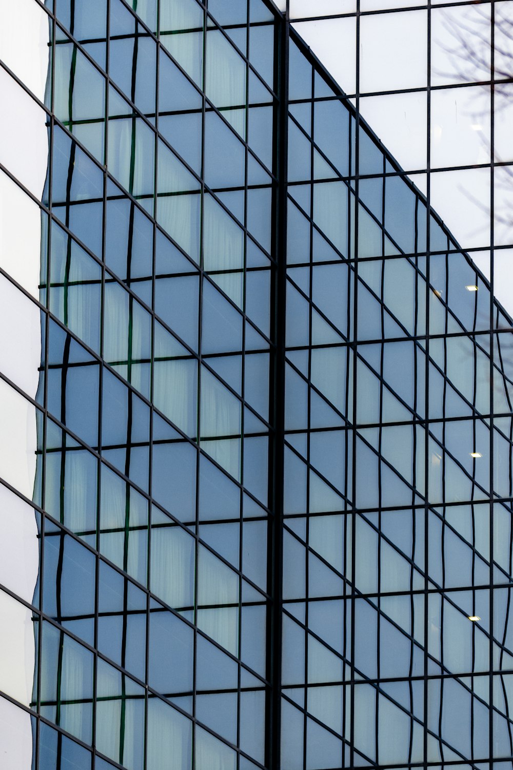 an airplane is flying in the sky near a building