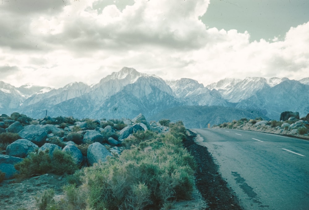 a scenic view of a mountain range and a road