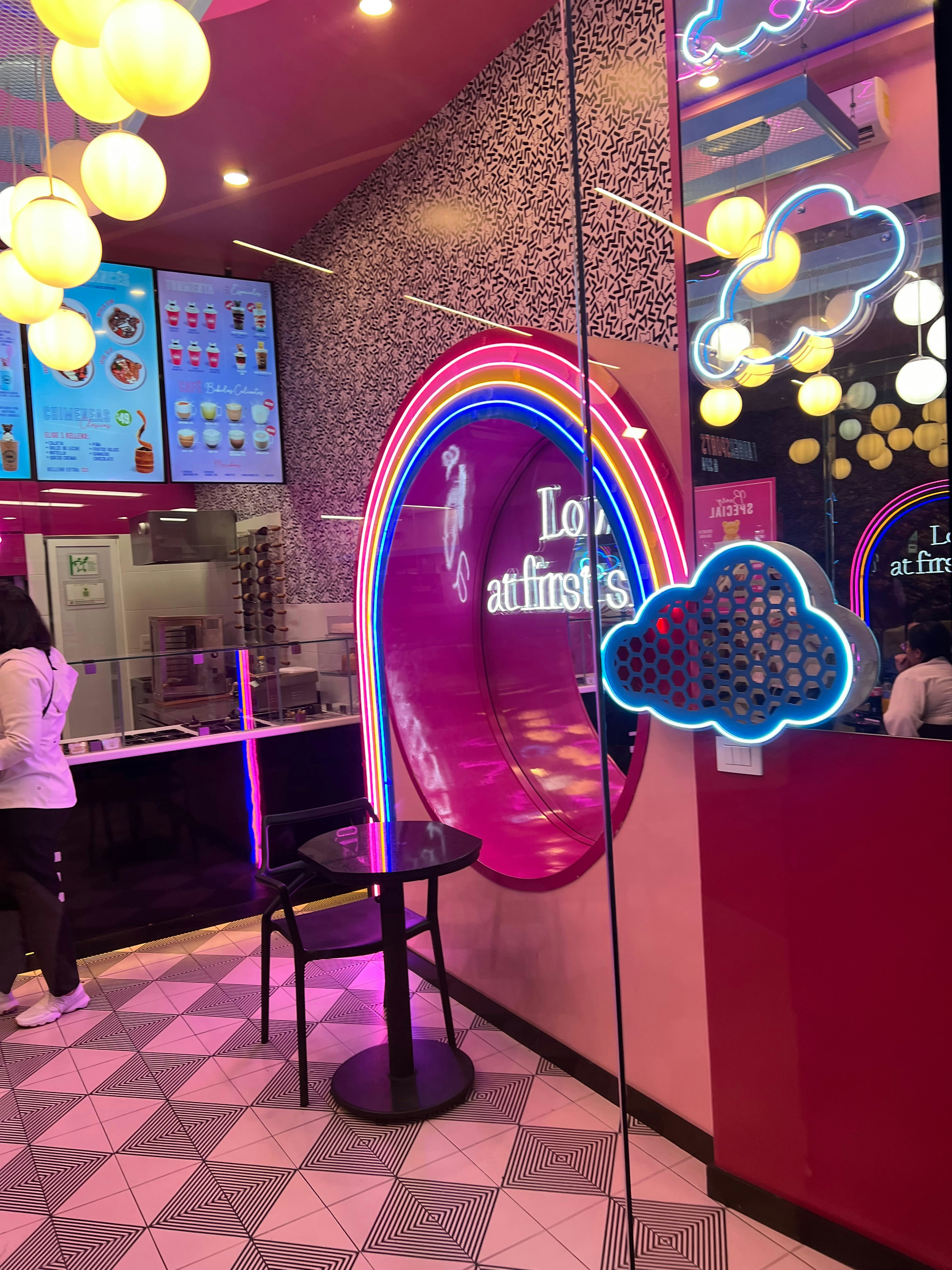 Stylish new bar interior with neon lights, rainbow decor and welcoming atmosphere