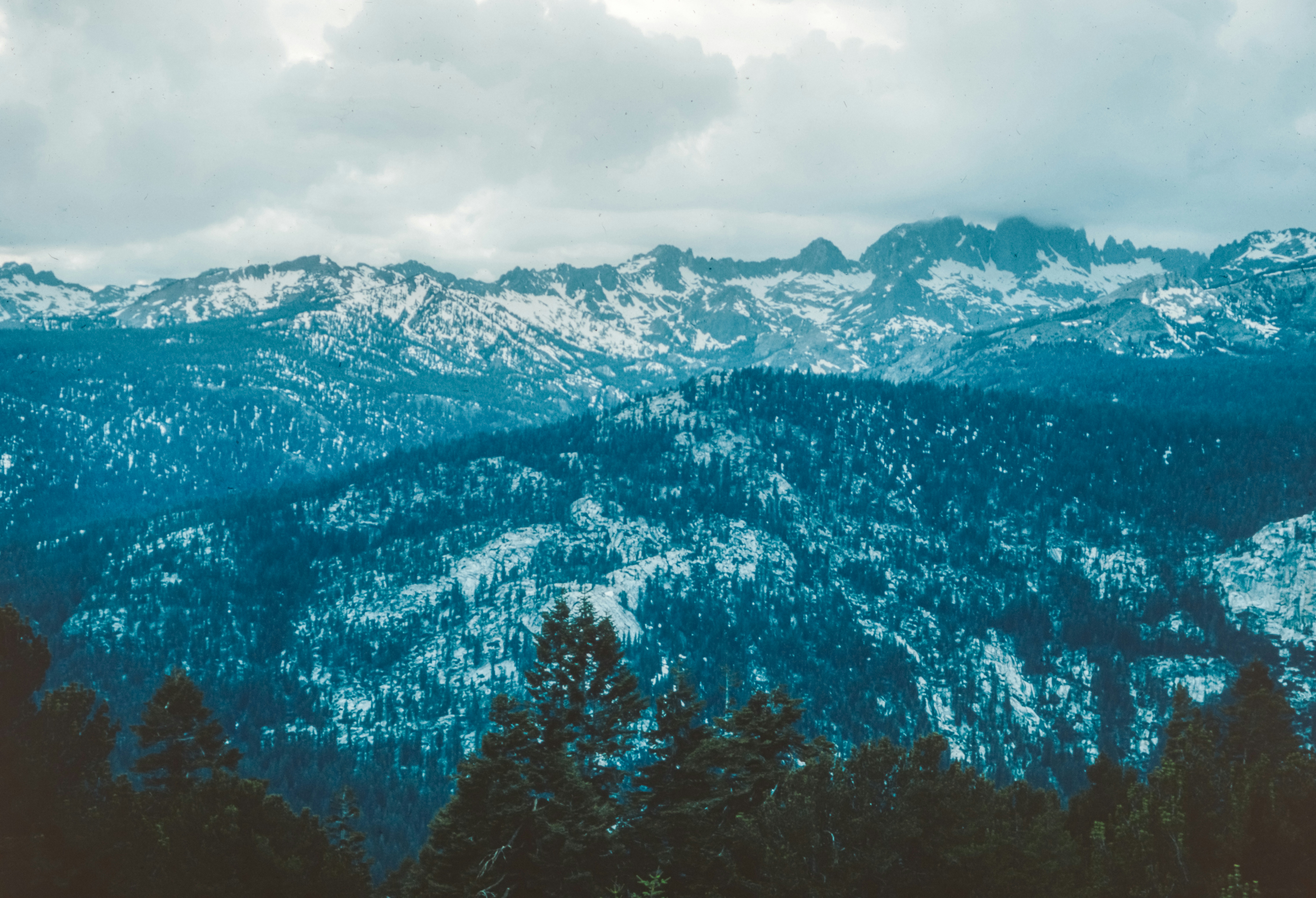 a view of a mountain range covered in snow, View from Minaret Point looking over the Sierra Nevada Mountain Range. 1961