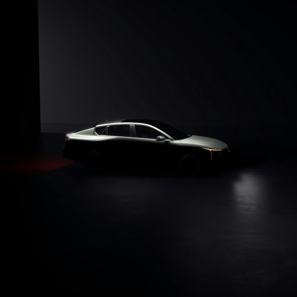 a car is shown in a dark room
