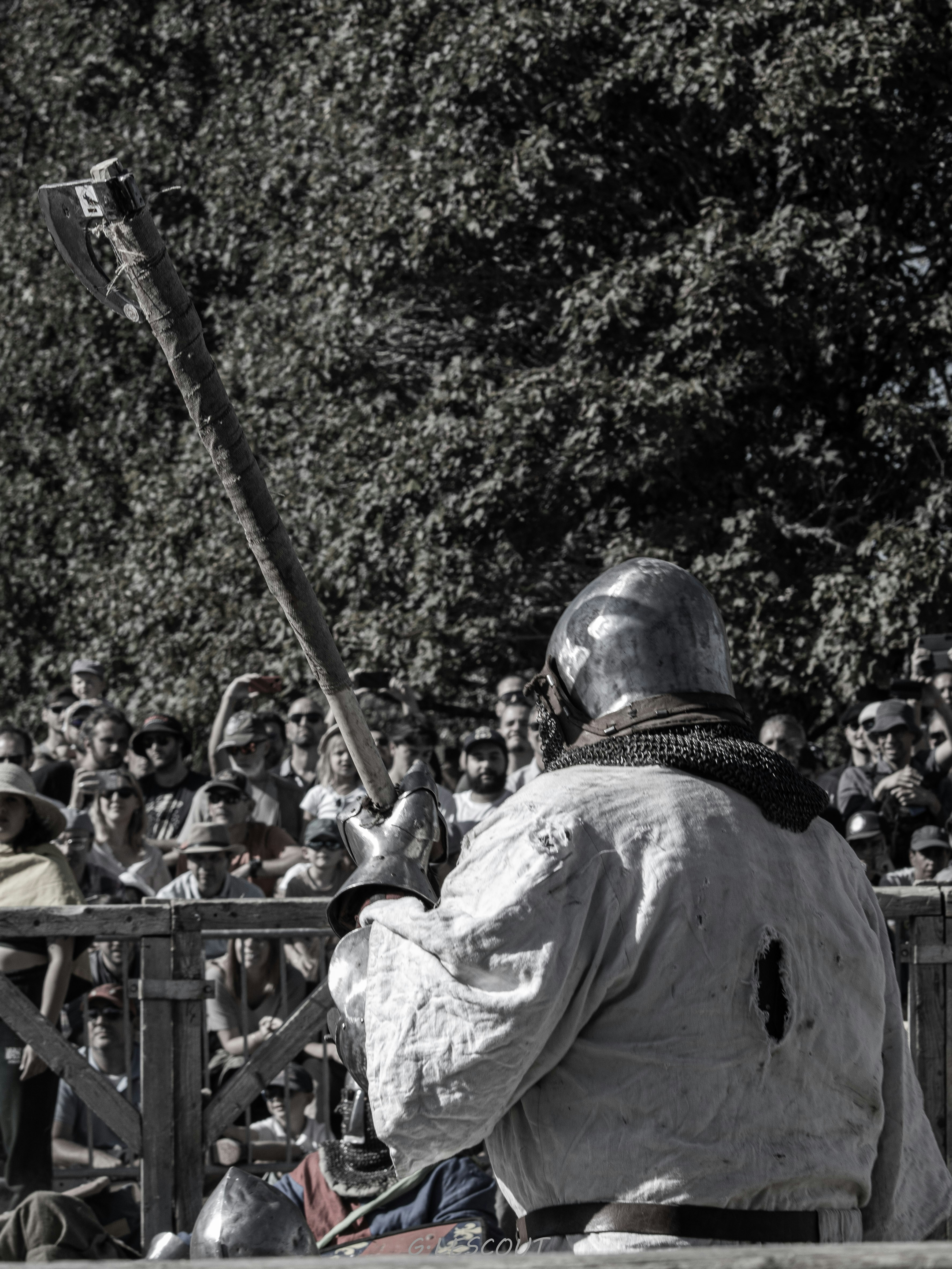 a man sitting on a bench in front of a crowd