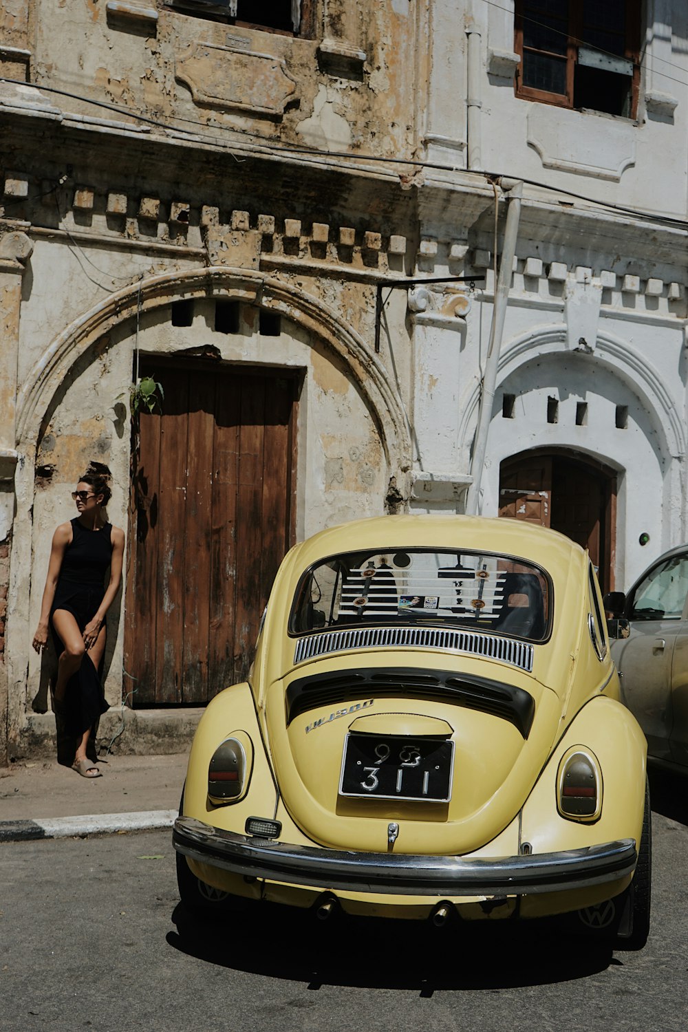 a yellow car parked in front of a building