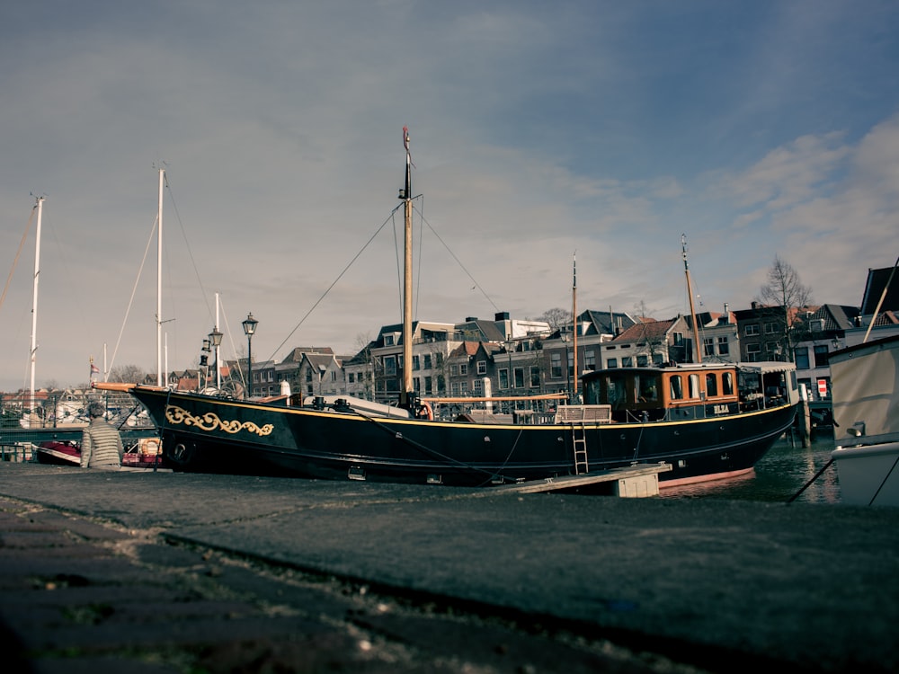 a boat is docked in a harbor with buildings in the background