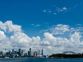a large body of water with a city in the background