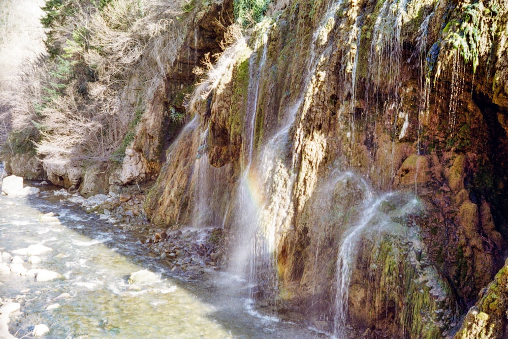 a waterfall with a rainbow in the middle of it