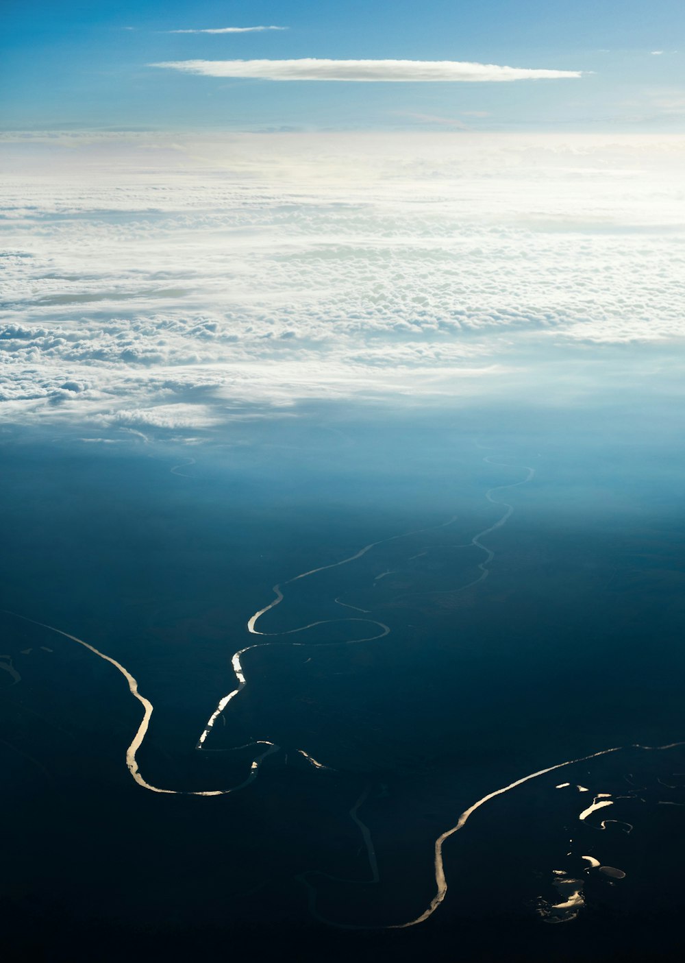 an aerial view of a river in the sky