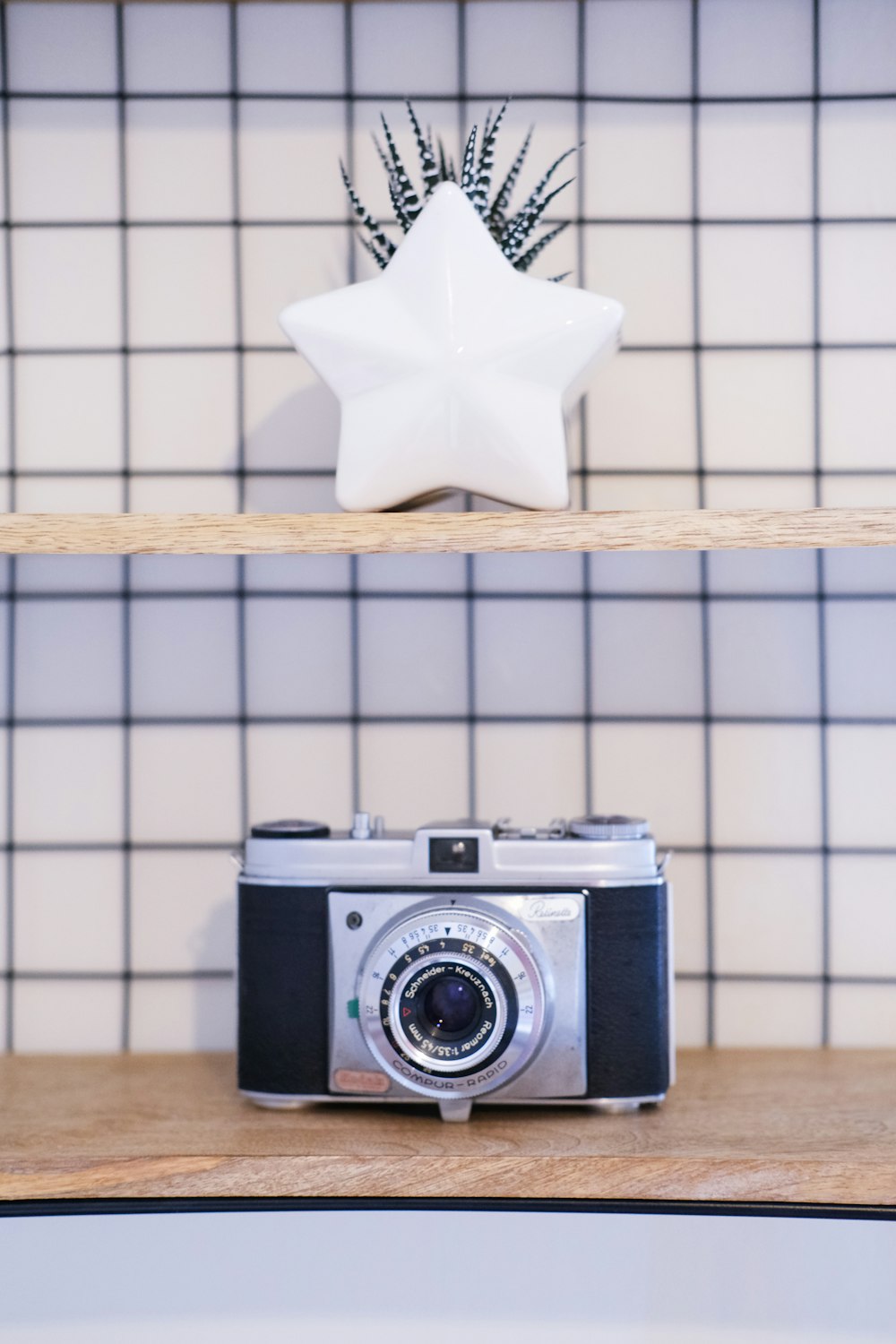 a camera sitting on top of a wooden shelf