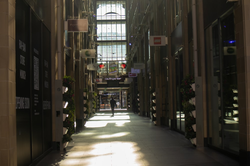 a long hallway with a person walking down it