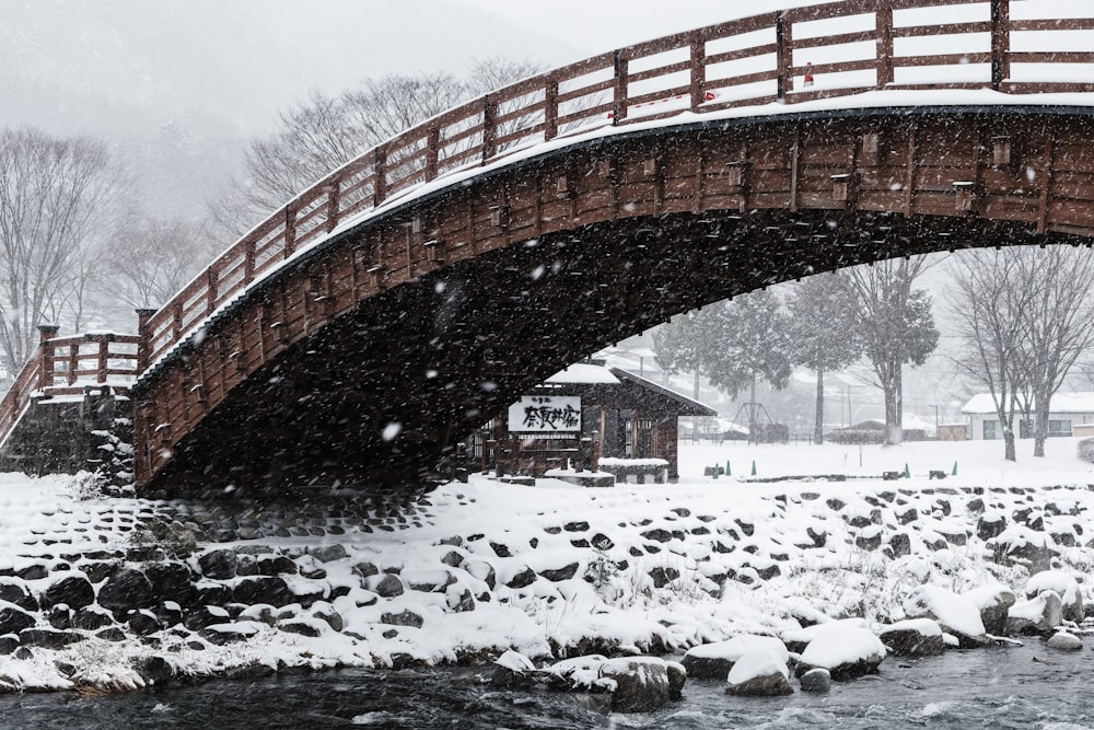 a bridge that is over a river in the snow