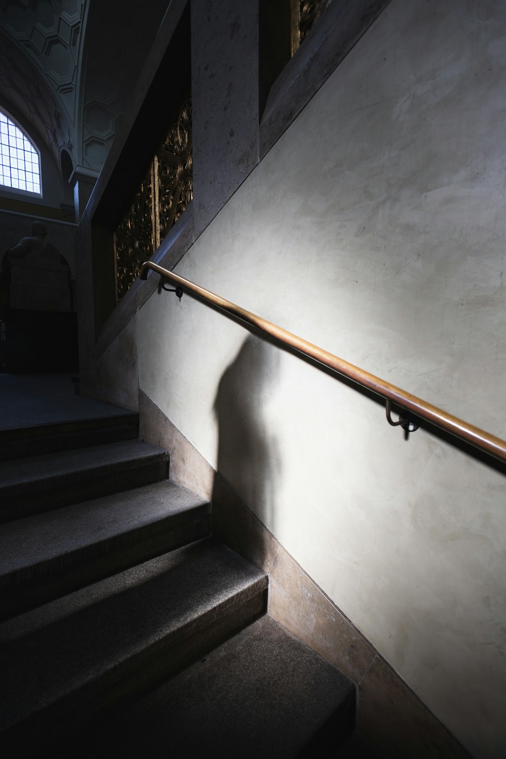 a shadow of a person on a stair case