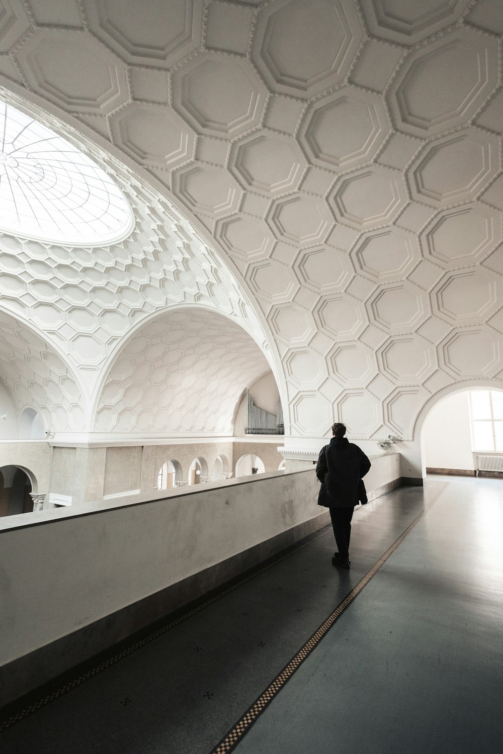 a person walking down a long hallway in a building