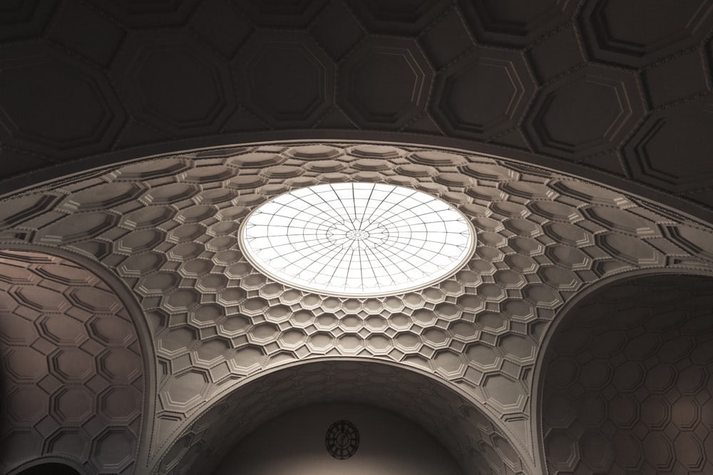 the ceiling of a church with a circular window