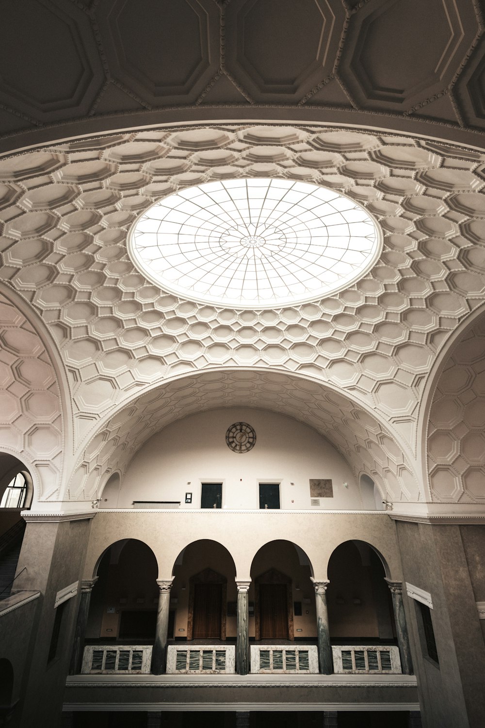 the ceiling of a large building with a clock on it