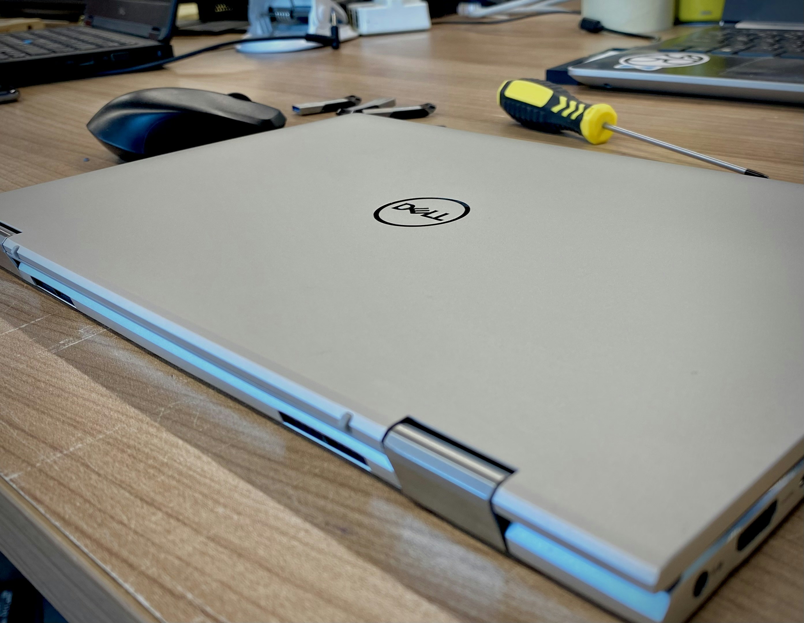 Dell laptop computer on dark surface, professional business laptop, side lighting